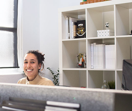 A woman on a desk smiling