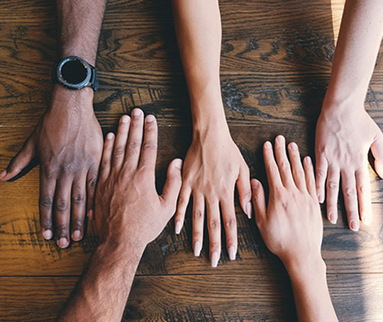 People's hands on a table